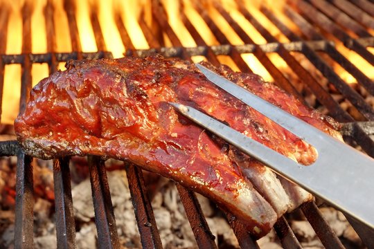 Pork Spare Ribs On The Hot Flaming  Barbecue Grill