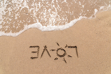 Fototapeta na wymiar Love Word On Ocean Beach Sand