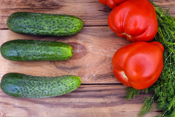 fresh vegetables, cucumbers, tomatoes and fennel on wooden background