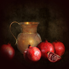 Chiaroscuro vintage still life,old brass jug with pomegranate