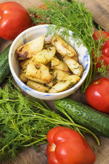 homemade food, fried potatoes, tomatoes, cucumbers and fennel on wooden table