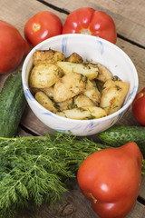 homemade food, fried potatoes, tomatoes, cucumbers and fennel on wooden table