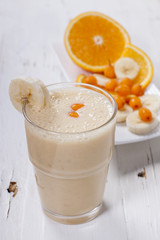 Smoothie of banana, orange juice , frozen sea-buckthorn   with y