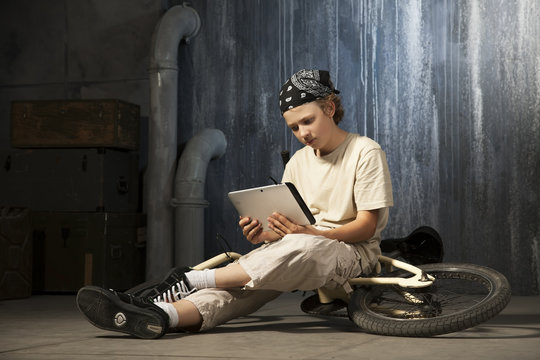 teenager sitting with tablet pc