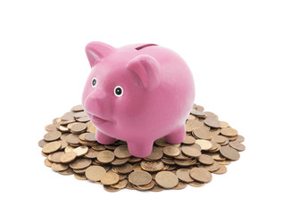Pink piggy bank on a pile of coins