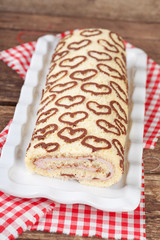 Homemade sponge roll with chocolate patterns and cottage cheese