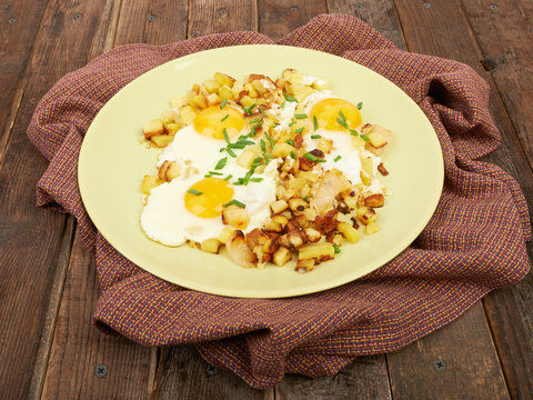 Fried potatoes with eggs on the table