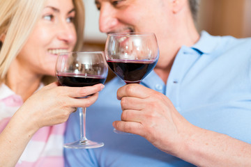 Mature couple enjoying a glass of red wine