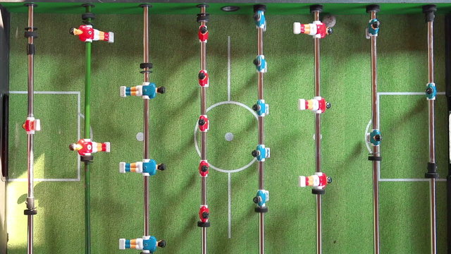 Vintage Foosball Known as Table Soccer, Blue and Red Players in Football Kicker Game, Selective Focus, Retro Cinematic Tone Effect