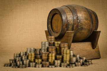 Stack of coins with wooden barrel