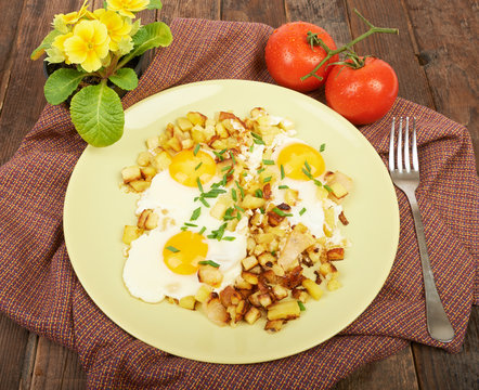 Fried potatoes with eggs on the table