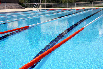 View of lane rope in an outside Olympic pool.