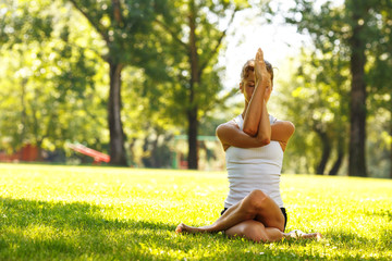 Young female doing yoga in nature.