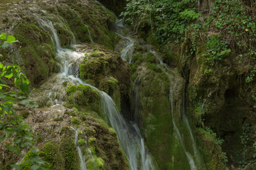Wild natural waterfall in a deep mountain forest