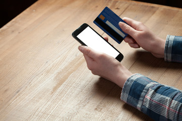 Businesswoman Paying With Credit Card On Mobile Phone