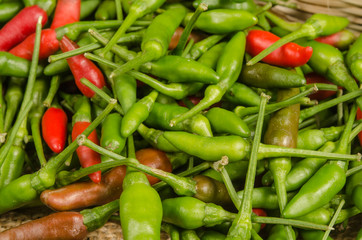 Green and red Thai chili peppers
