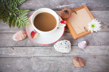 board with coffee and flower on wooden table in vintage tone
