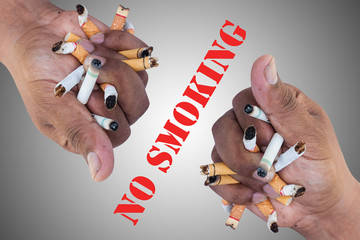 Hand Man Crushing Cigarettes Concept No Smoking on gray background