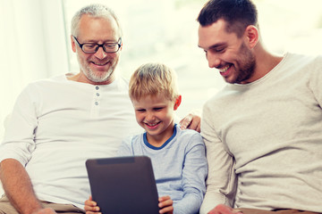 smiling family with tablet pc at home