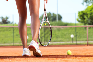 Plakat Legs of female tennis player.Close up image.
