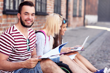 Group of happy students studying outdoors