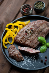 Frying pan with medium grilled barbecue beef steak, close-up