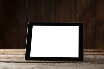 digital tablet computer with isolated screen over old grey wooden background table