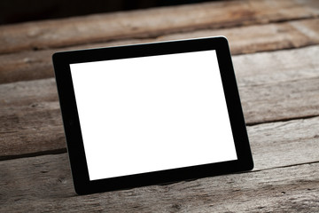 digital tablet computer with isolated screen over old grey wooden background table
