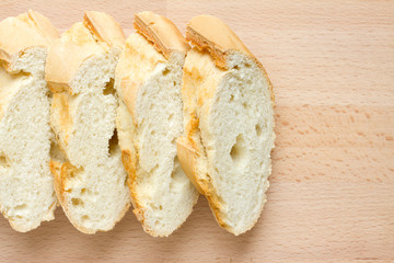 Sliced fresh baguette on a wooden board