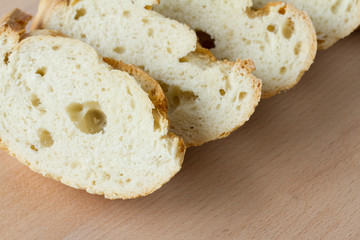 Sliced fresh baguette on a wooden board
