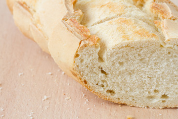 Sliced fresh baguette on a wooden board