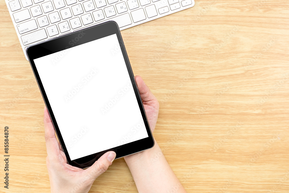 Poster Hand holding Digital Tablet computer with empty screen and keybo