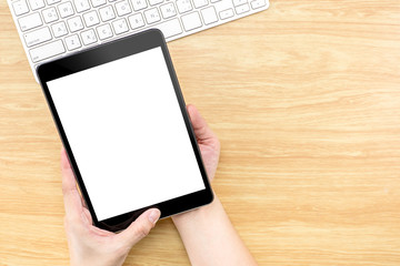 Hand holding Digital Tablet computer with empty screen and keybo