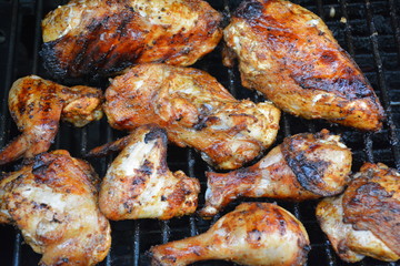 Golden brown chicken cooking on barbecue