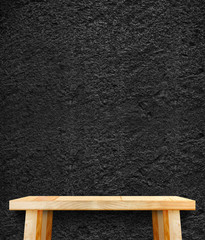 Empty wood modern table and black rough stone wall in background