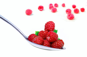 ripe raspberries in a spoon