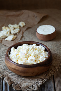 Traditional homemade cottage cheese with sour cream in rustic