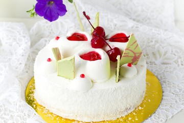white cake with cherries