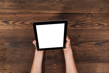 Woman using tablet on wooden planks