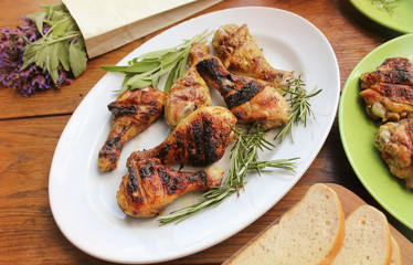 Grilled chicken legs on table