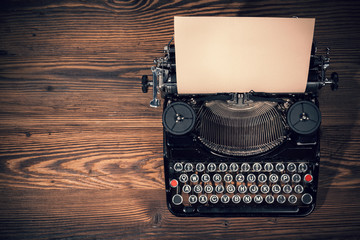 Retro typewriter on wooden planks