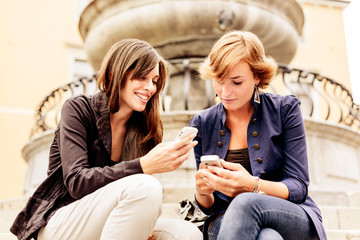 Women using mobile phone. Social networking.