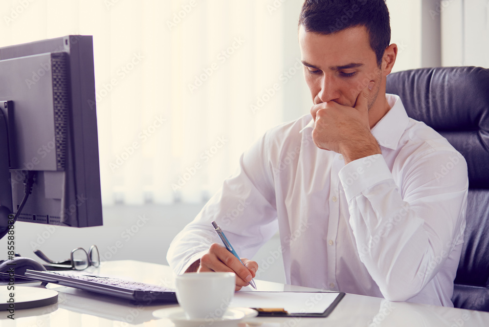 Poster young businessman with a pen in the office, toned