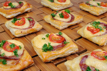 Appetizer of puff pastry with salami