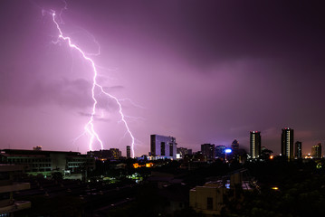 Fototapeta na wymiar Strike of lightning into building in city.