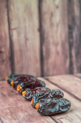 Date fruits over wooden background