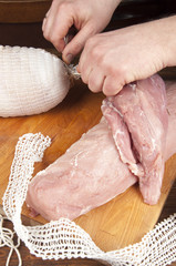 making meats - men's hands are doing ham