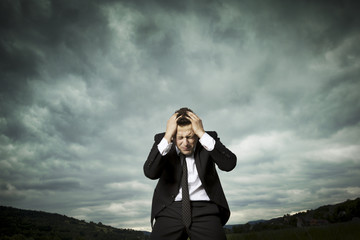 The young man responds to bad news. He Is worried and absent thoughts.
