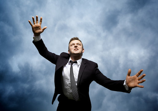 Crazy young man throws himself in front of him to attack. I want to catch something. He is furious and determined to reach your goal.