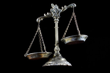 Law scales isolated on black background. Symbol of justice